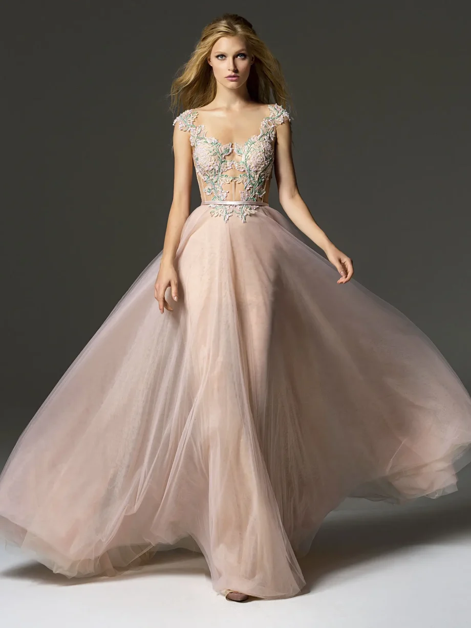 Front view of a blush evening dress with cap sleeves at Papilio Boutique's Toronto sample sale, showcasing detailed colorful embroidery and a detachable sash for an elegant appearance.