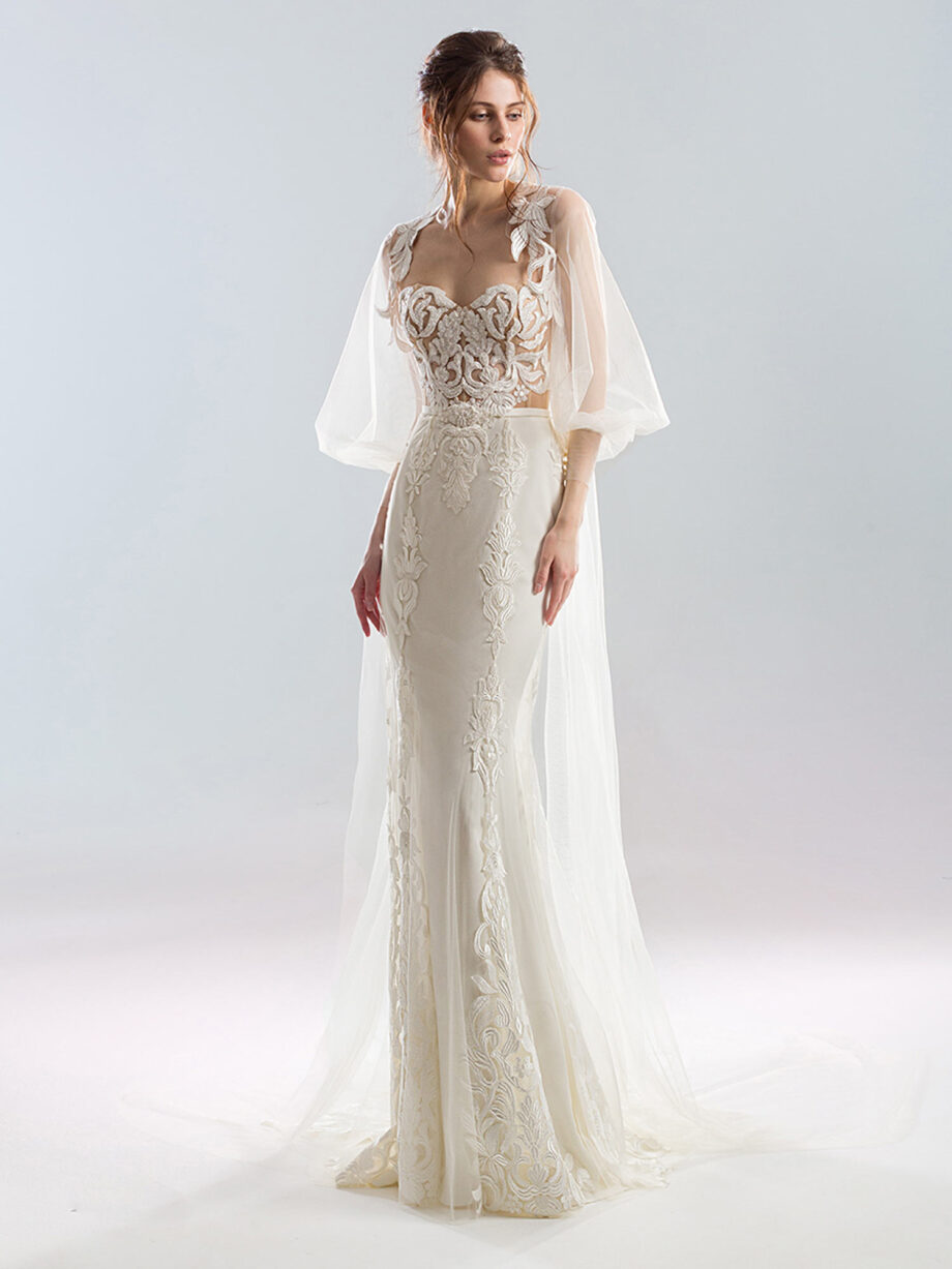 Front view of a strapless wedding dress with a fitted lace bodice and a bishop sleeve tulle cape, decorated with matching lace embroidery. Available at Papilio Boutique's sample sale in Toronto.