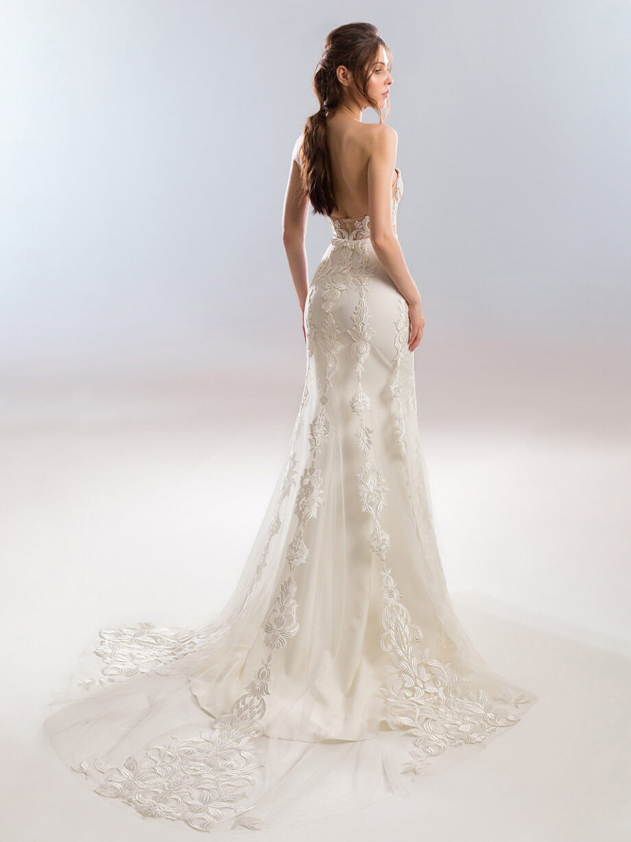 Back view of an elegant strapless wedding dress with fitted lace bodice in ivory-nude, featuring intricate lace embroidery, available at Papilio Boutique's sample sale in Toronto.