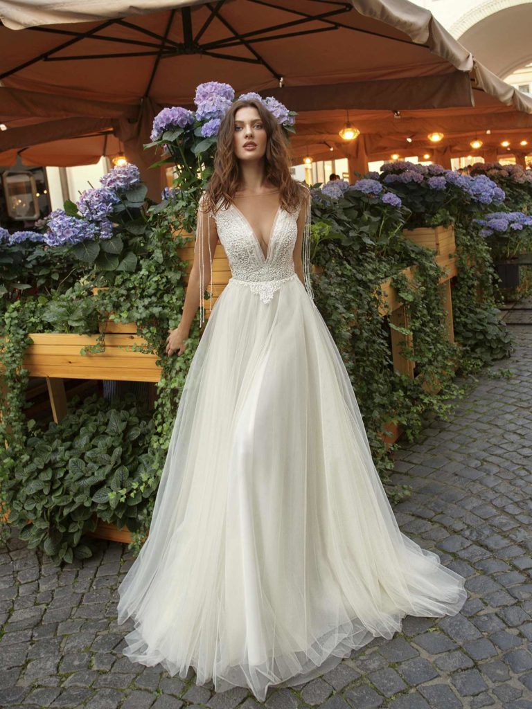 A-line wedding dress with tulle skirt, lace bodice and beading hanging ...