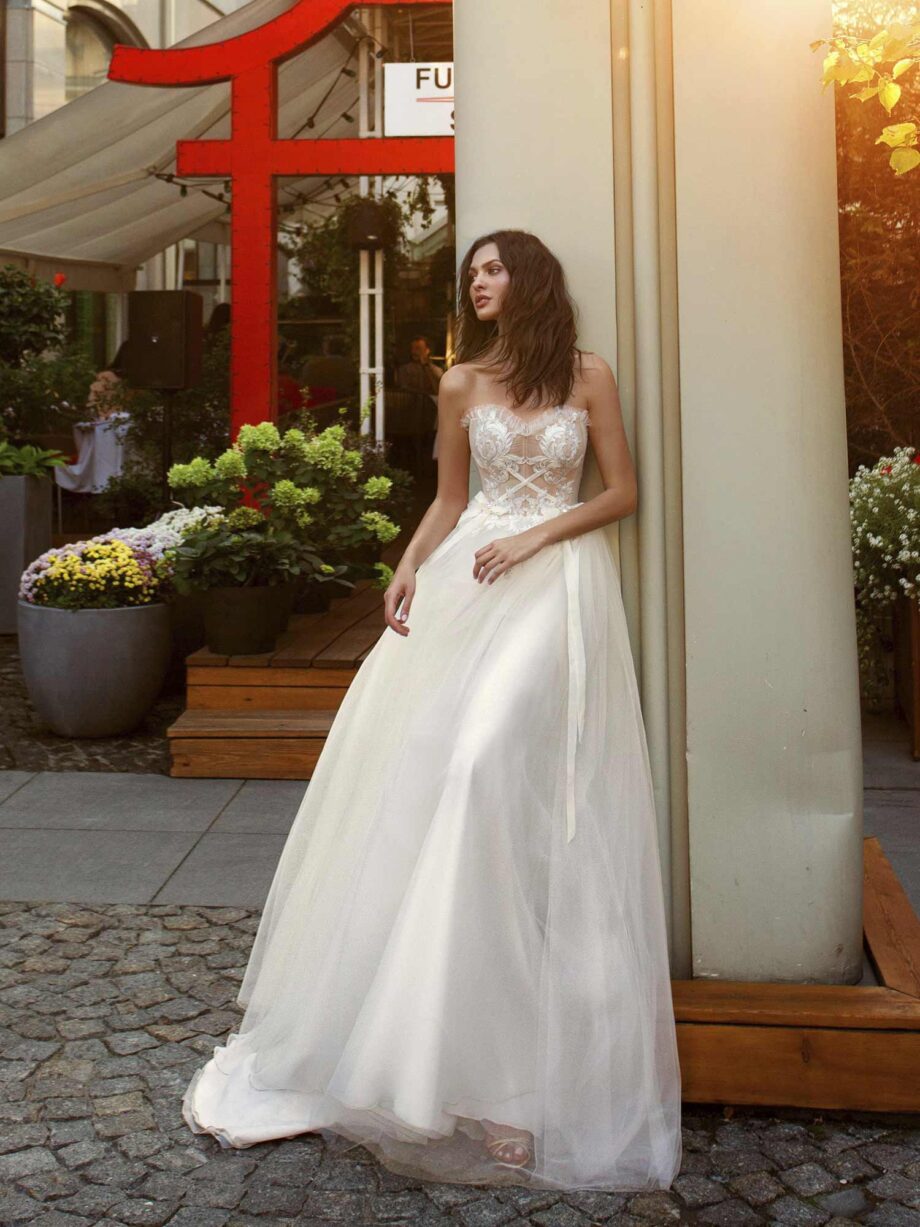 A-line wedding gown with a nude sweetheart bodice and ivory embroidery