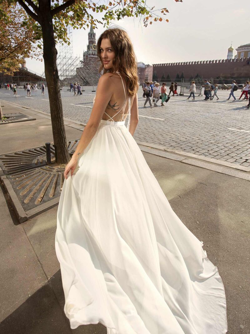 Wedding gown with a crisp chiffon skirt and pure lace bodice with plunging neckline and open back