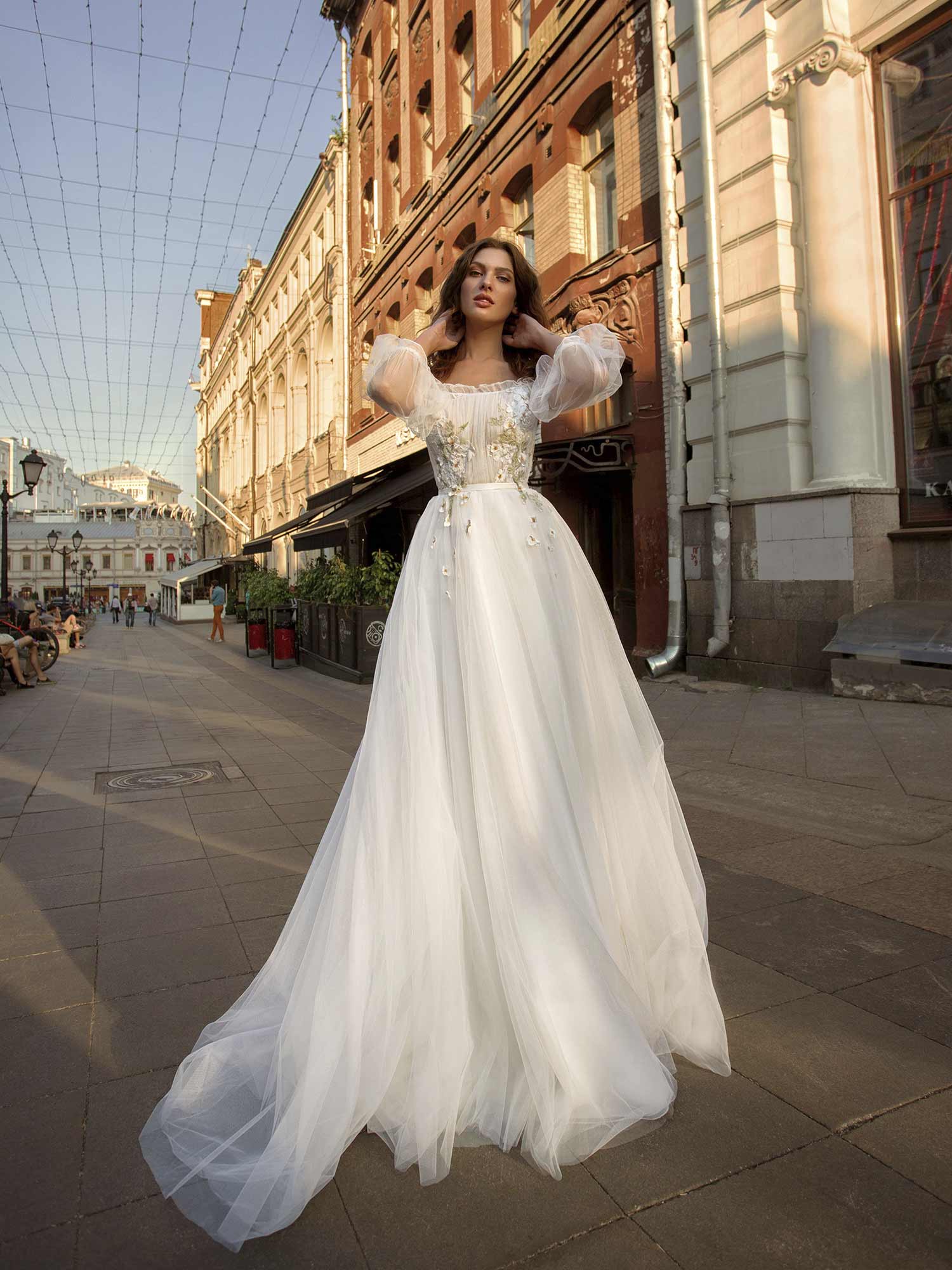 A-line wedding gown with an off-the-shoulder neckline, bishop sleeves, and  floral appliqué
