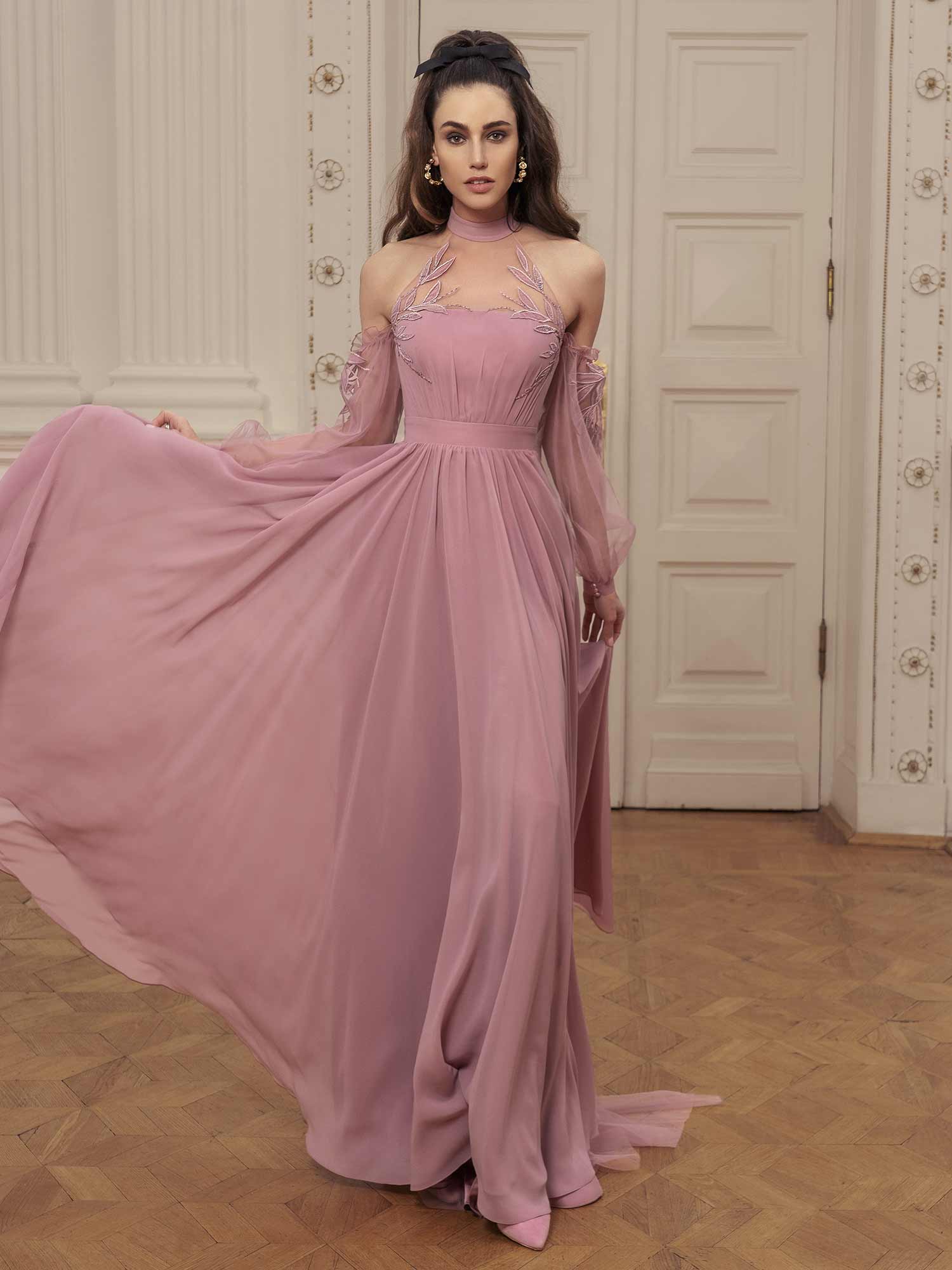 Evening gown with high neckline, bishop sleeves, and cape
