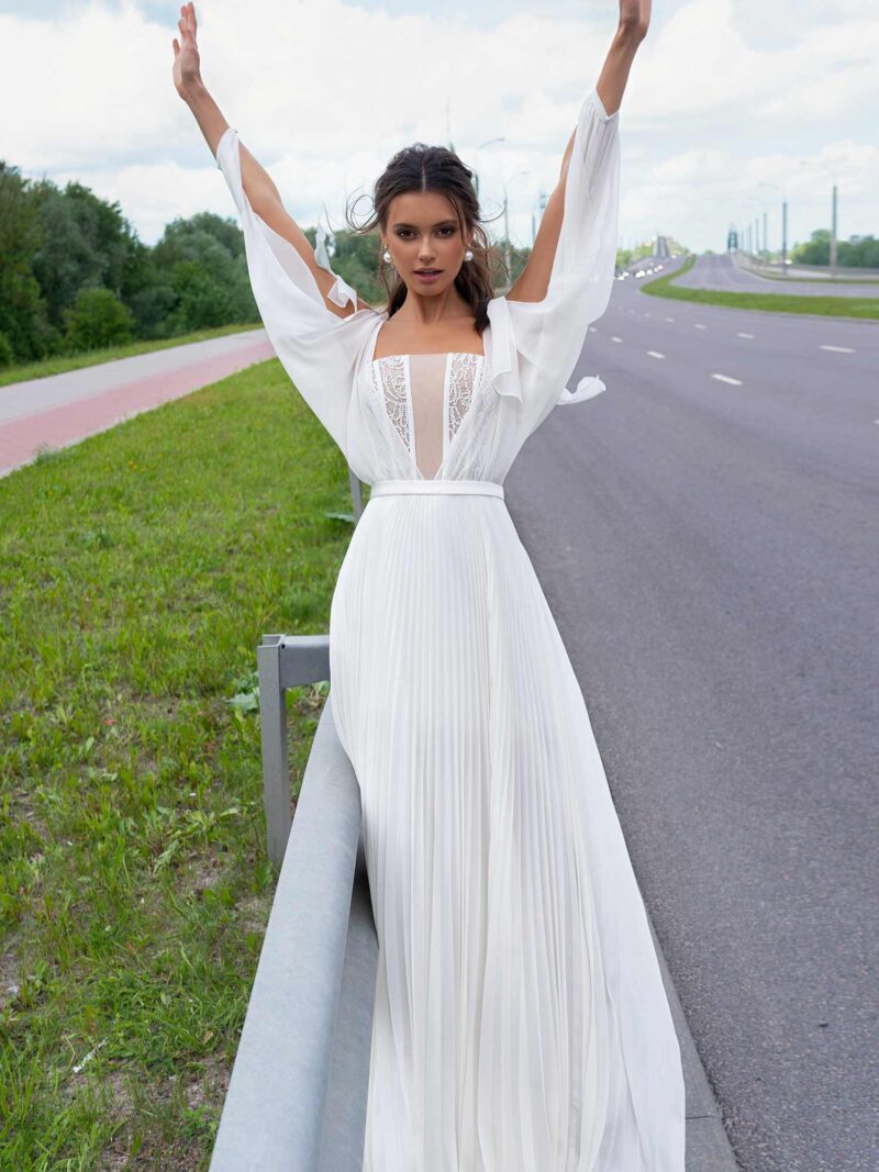 Modern wedding dress with pleated skirt and long cutout sleeves