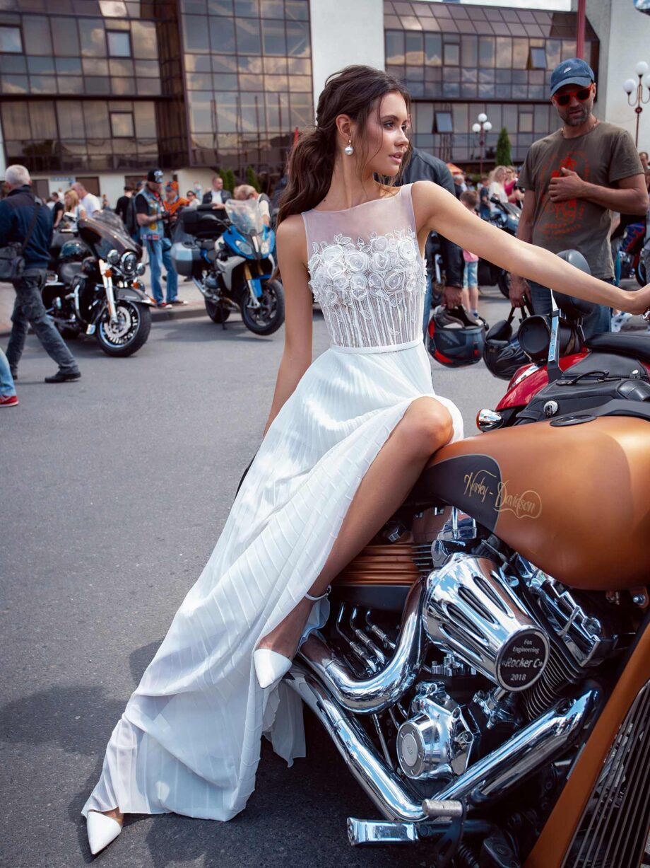 Simple wedding dress with floral applique and pleated skirt