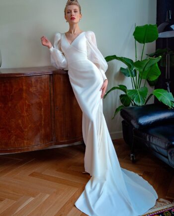 Front view of a fit and flare wedding dress with bishop sleeves and pleated chiffon detailing – Papilio Boutique bridal store Toronto.