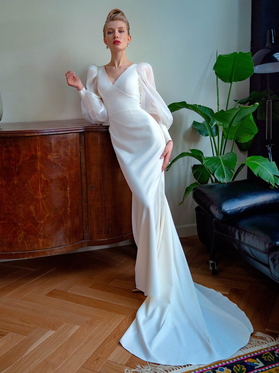 Front view of a fit and flare wedding dress with bishop sleeves and pleated chiffon detailing – Papilio Boutique bridal store Toronto.