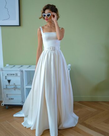 Minimalist satin ball gown with square neckline and detachable belt, showcased at Papilio Boutique bridal store in Toronto.