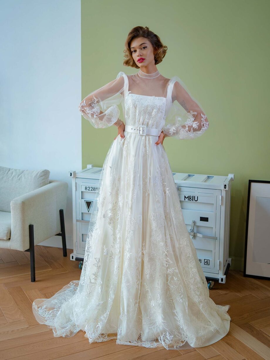 Elegant ball gown with high neck and lace sleeves, highlighting the removable tulle overlay, revealing a chic A-line satin dress, from Papilio Boutique.