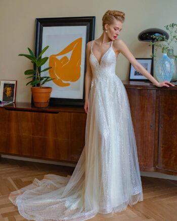 A sparkling A-line wedding dress with spaghetti straps and sequinned lace, displayed from the back, featuring a crisscross strap design. Papilio Boutique evening dresses store in Toronto.