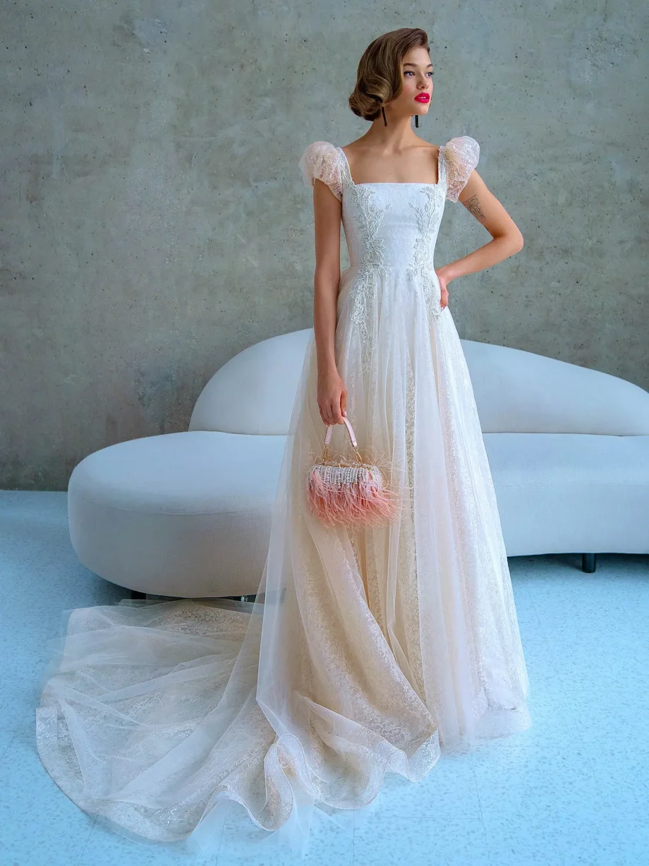 Elegant wedding dress with cap sleeves and a structured square neckline, featuring lace appliqués and a dreamy tulle skirt – Papilio Boutique Toronto.