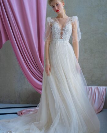 Romantic wedding gown with puff sleeves, plunging bodice, and sparkling tulle skirt, available at Papilio Boutique.