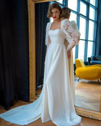 Wedding dress with bishop sleeves featuring a soft sweetheart neckline and a long flowing train, available at Papilio Boutique.