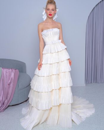 Strapless tiered A-line wedding dress with pleated taffeta and a lace-up bodice, featuring an adjustable belt, available at Papilio Boutique.