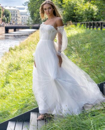 Ball gown wedding dress with asymmetric neckline and long sleeves