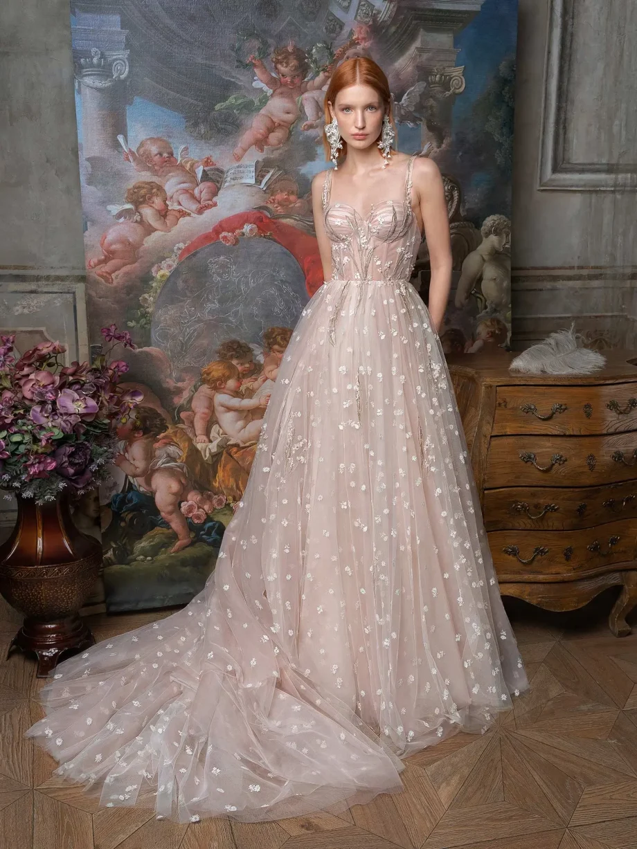 Full-length front view of a bride in a pink ballgown wedding dress; part of our sample sale Toronto with detailed floral applique.