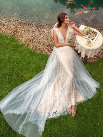 Fit and flare wedding gown with plunging neckline and overlay skirt