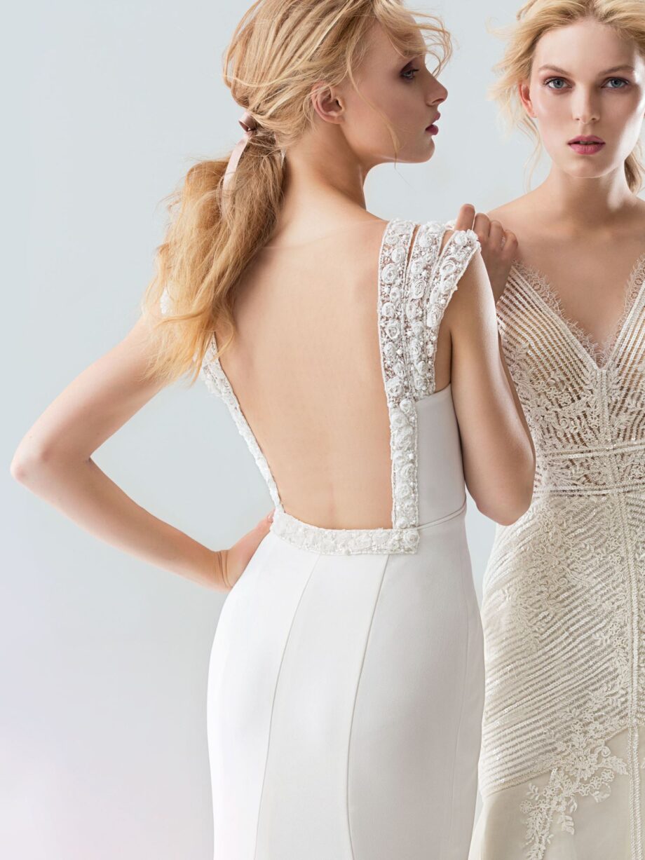 Elegant wedding dress available at Papilio Boutique bridal store in Toronto, featuring embroidered and beaded straps, a mesh transparent back, and crepe fabric, part of the sample sale in Toronto.