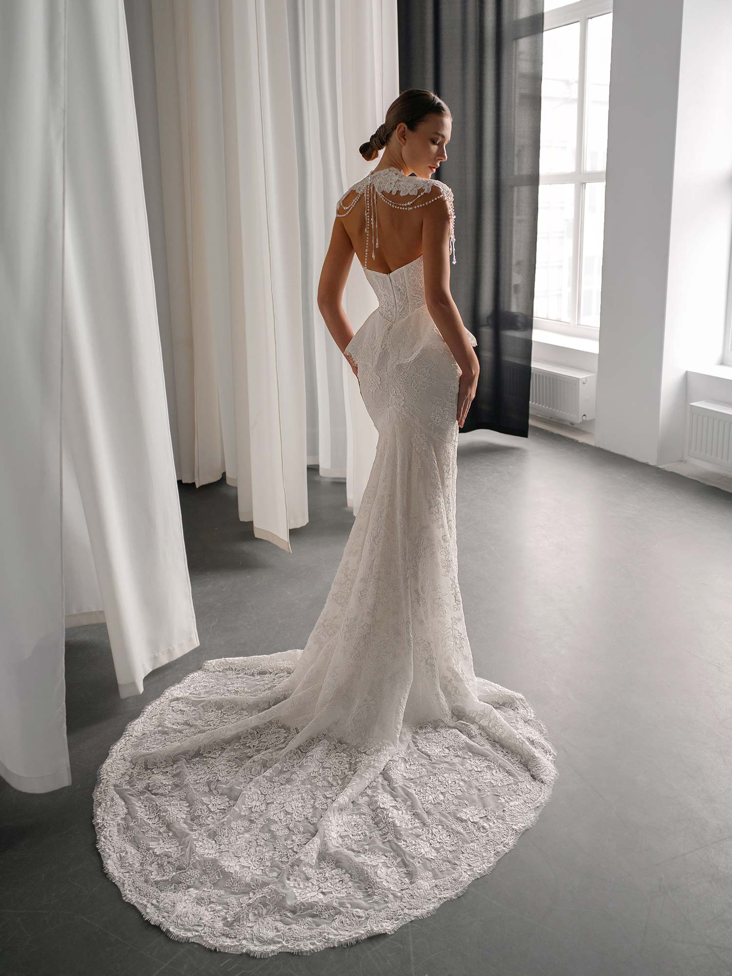 back view of basque waist fit and flare lace wedding dress with pearl-draped collar, available at bridal stores in Toronto