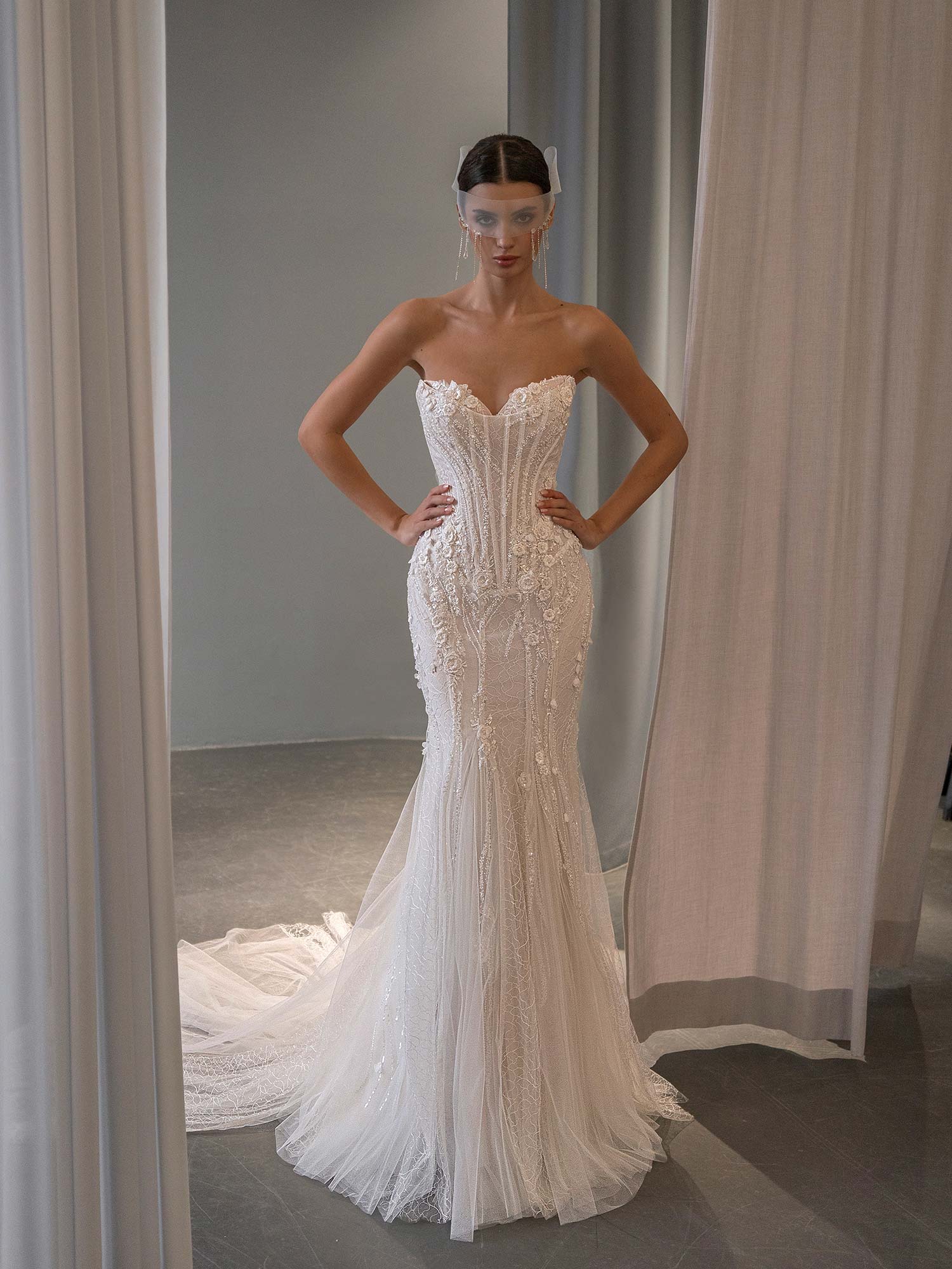 front view of fit and flare wedding dress with basque waist, scoop neckline with peekaboo cups, and mixed tulle and patterned lace by Papilio Boutique bridal store in Toronto