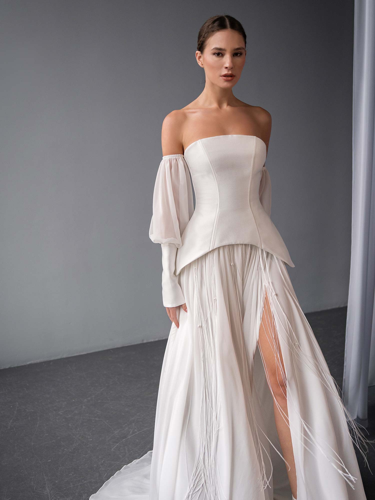 close-up of two piece wedding dress with corset top and beaded skirt by Papilio Boutique in Toronto, featuring mikado bodice and flowing chiffon skirt