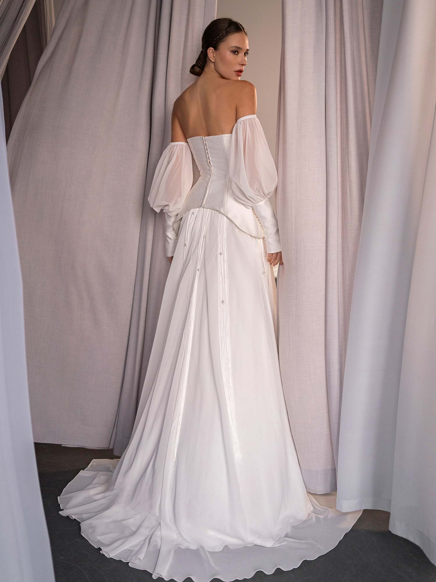 back view of modern two piece wedding dress with corset top and beaded skirt by Papilio Boutique in Toronto, styled with detachable long sleeves