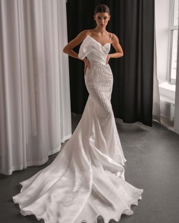 Model wearing a beaded organza mermaid wedding dress with an asymmetrical neckline, photographed at Papilio Boutique bridal store in Toronto.