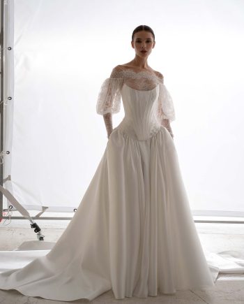 Papilio two piece wedding dress in Toronto featuring corset, dropped-waist skirt, and long-sleeve lace bolero.