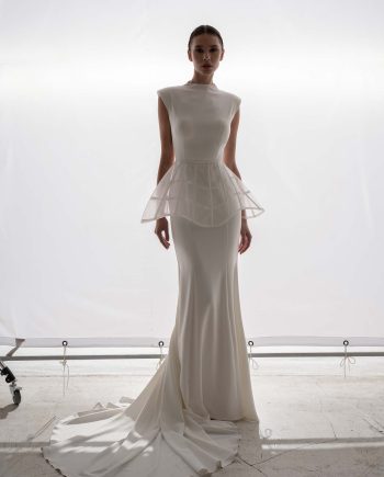 High-neck fit and flare wedding dress with detachable peplum by Papilio Boutique bridal store in Toronto, shown in a clean studio setting.
