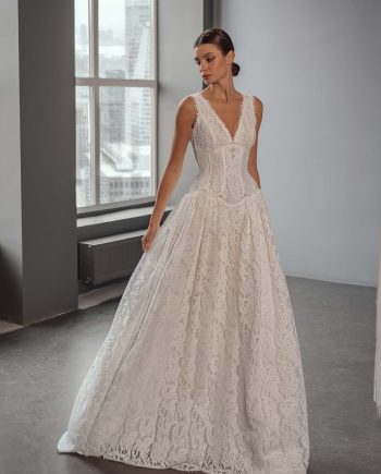 Model wearing a lace A-line wedding dress with a V-neck and beaded basque waist, photographed at Papilio Boutique bridal store in Toronto.