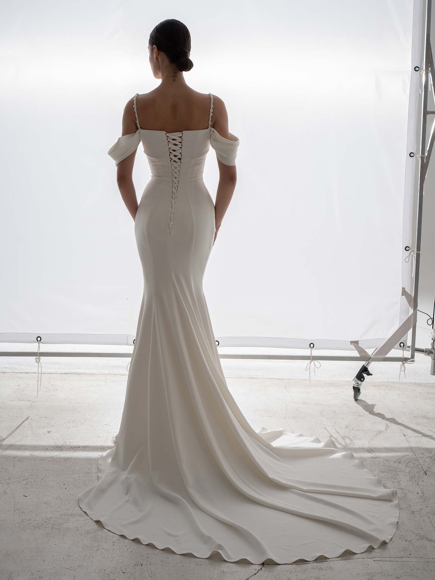 Crepe fit and flare simple wedding dress with beaded spaghetti straps and lace-up back by Papilio Boutique, Toronto bridal store.