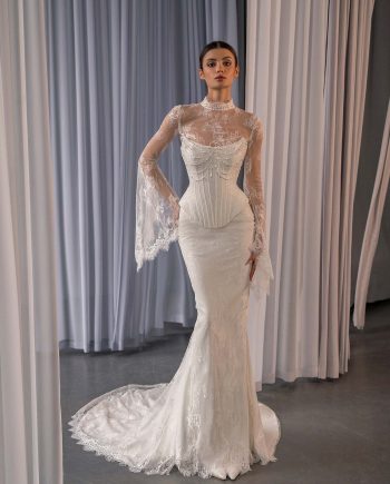 Lace fit and flare wedding dress with bell sleeves by Papilio Boutique, shown at a Toronto bridal store.
