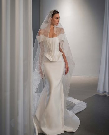 Simple off the shoulder wedding dress with basque waist by Papilio Boutique Toronto bridal shop.