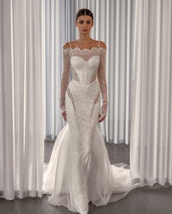 Sparkling off the shoulder wedding dress with long sleeves by Papilio Boutique, with sequins and nude-lined cutouts, from a Toronto bridal shop.