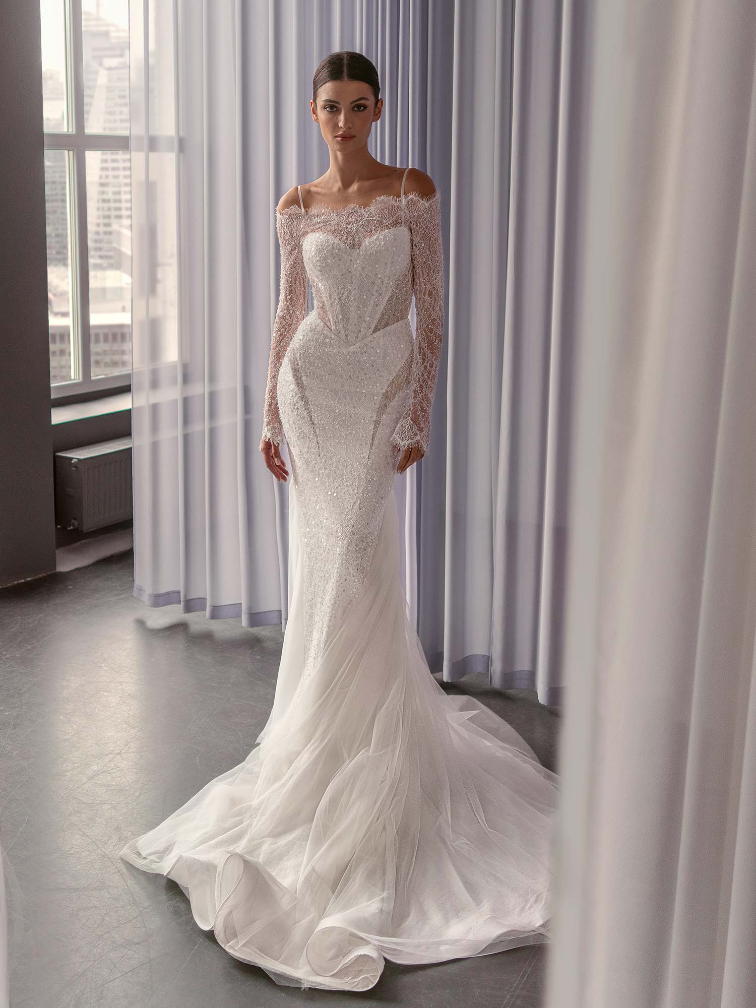 Sequin off the shoulder wedding dress with long sleeves by Papilio Boutique, designed with a basque waist and couture detailing, from a Toronto bridal store.