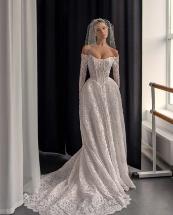 Lace A-line wedding dress with long off the shoulder sleeves and flowing train, offered at Papilio Boutique Toronto.
