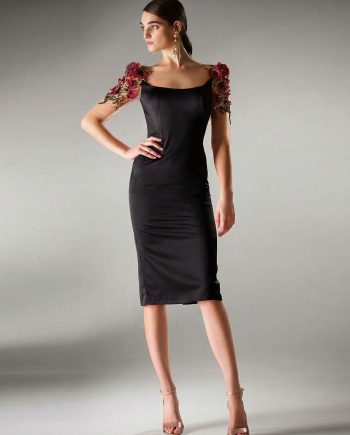 Black cocktail dress with floral sleeves by Papilio Boutique featuring 3D red and green floral appliqués on sheer sleeves.